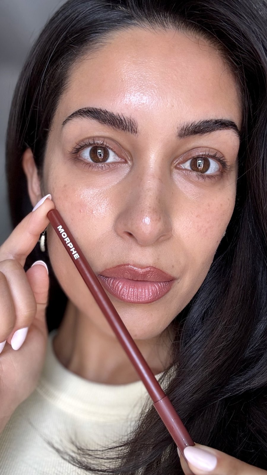 Rebecca applying lip pencil